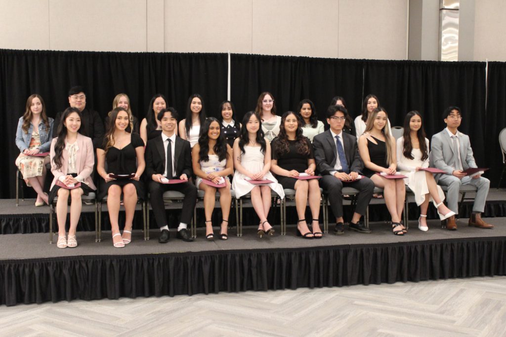 Students pose for photo in two rows. 