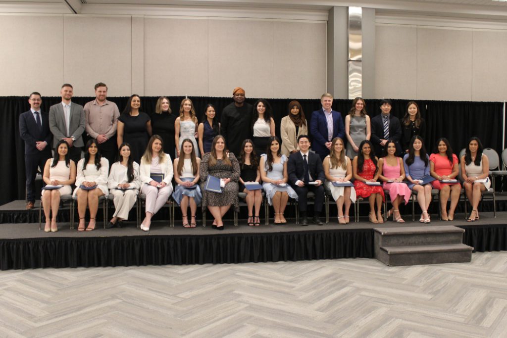 Students pose for photo in two rows. 