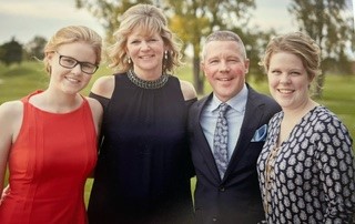 Dr. Plexman and Charlene pose for a photo with two other people. 