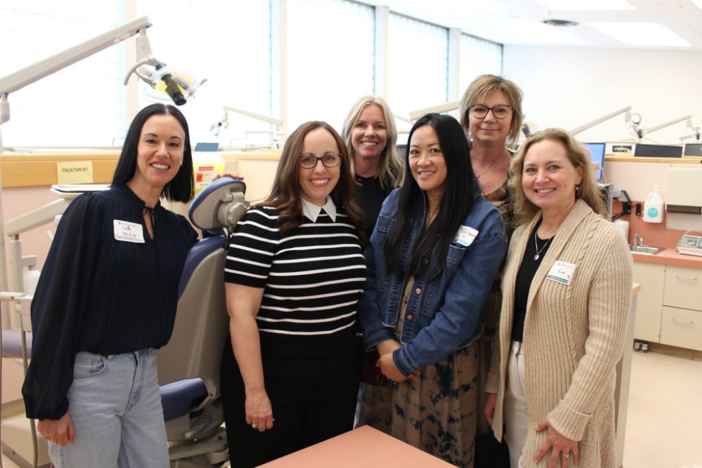 Six people pose for a photo in the clinic. 