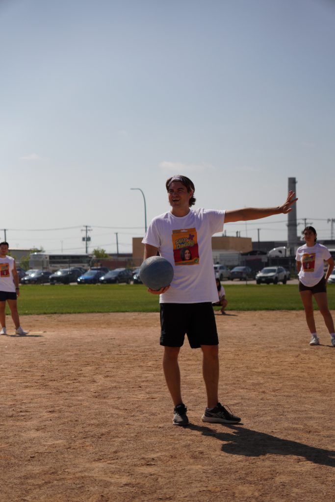 A person holds a ball. 