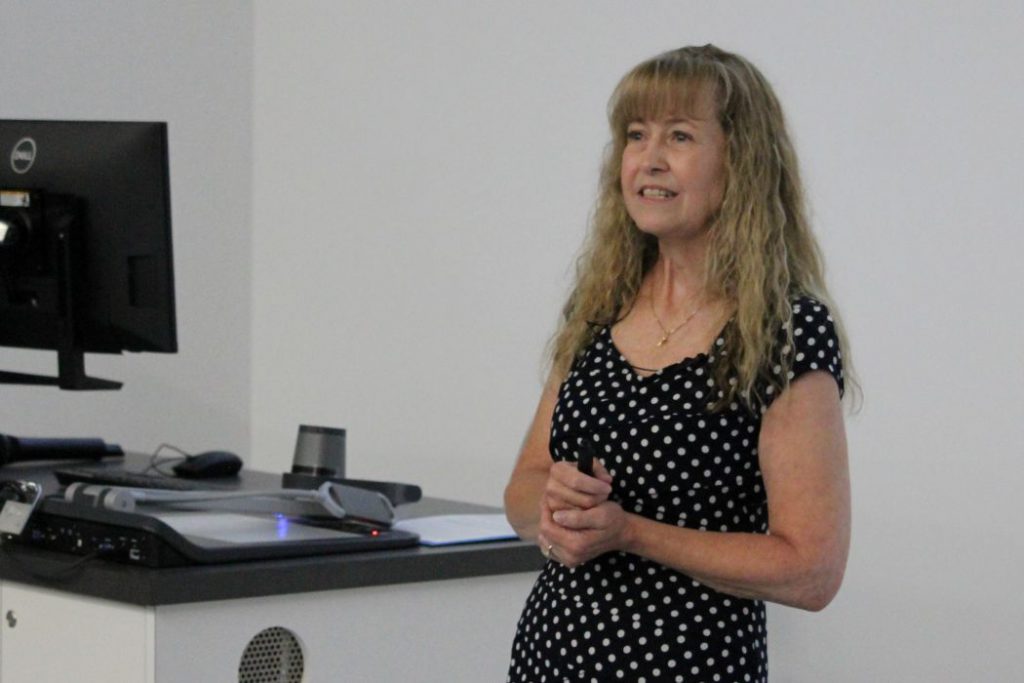 Jennifer Cicci speaks at the front of a lecture hall. 
