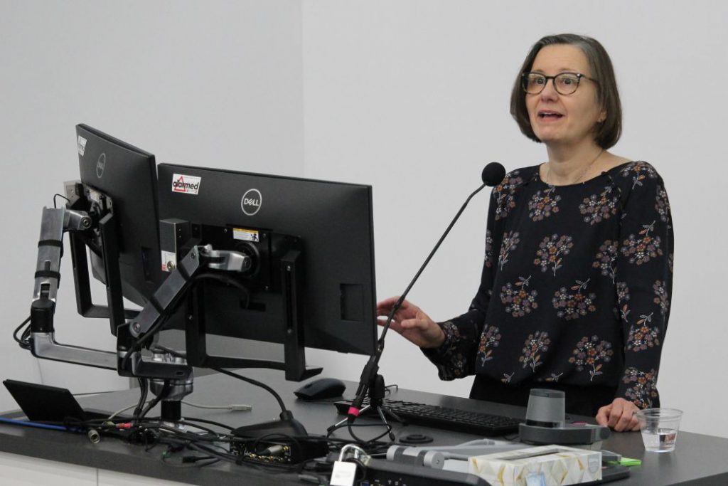 A person speaks into a microphone. 