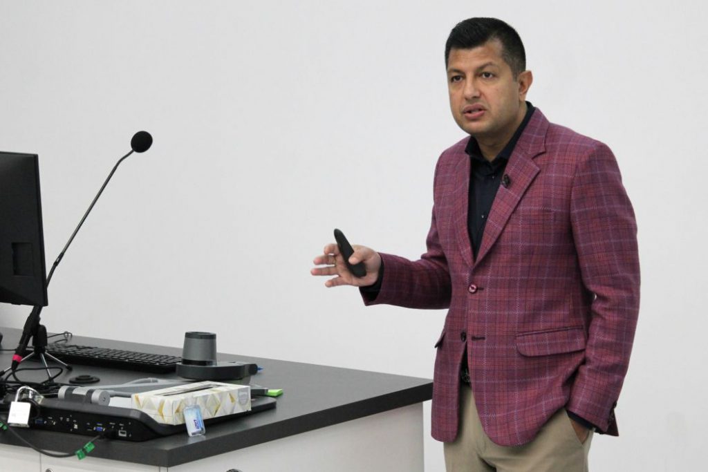 Person speaks next to a lectern. 