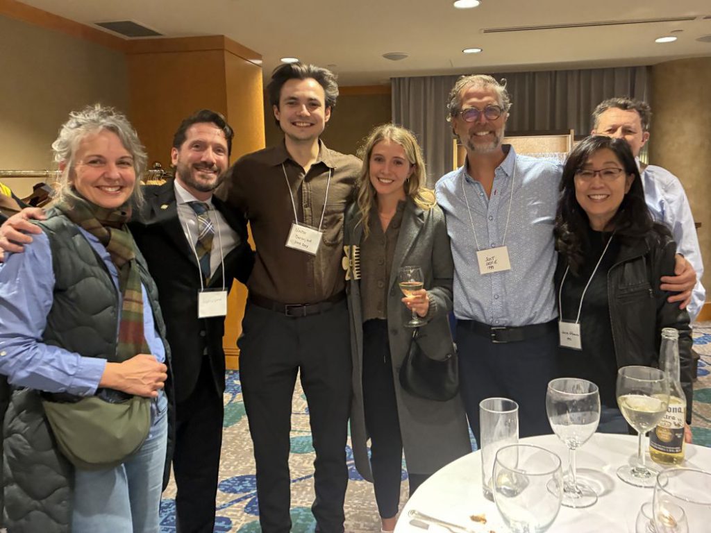 Seven people pose for a photo. 