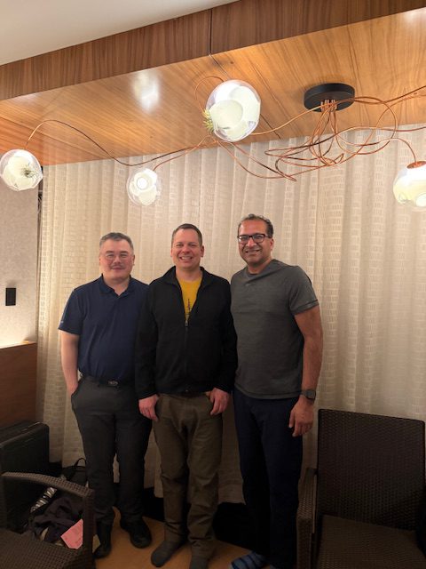 Three people pose for a photo. 