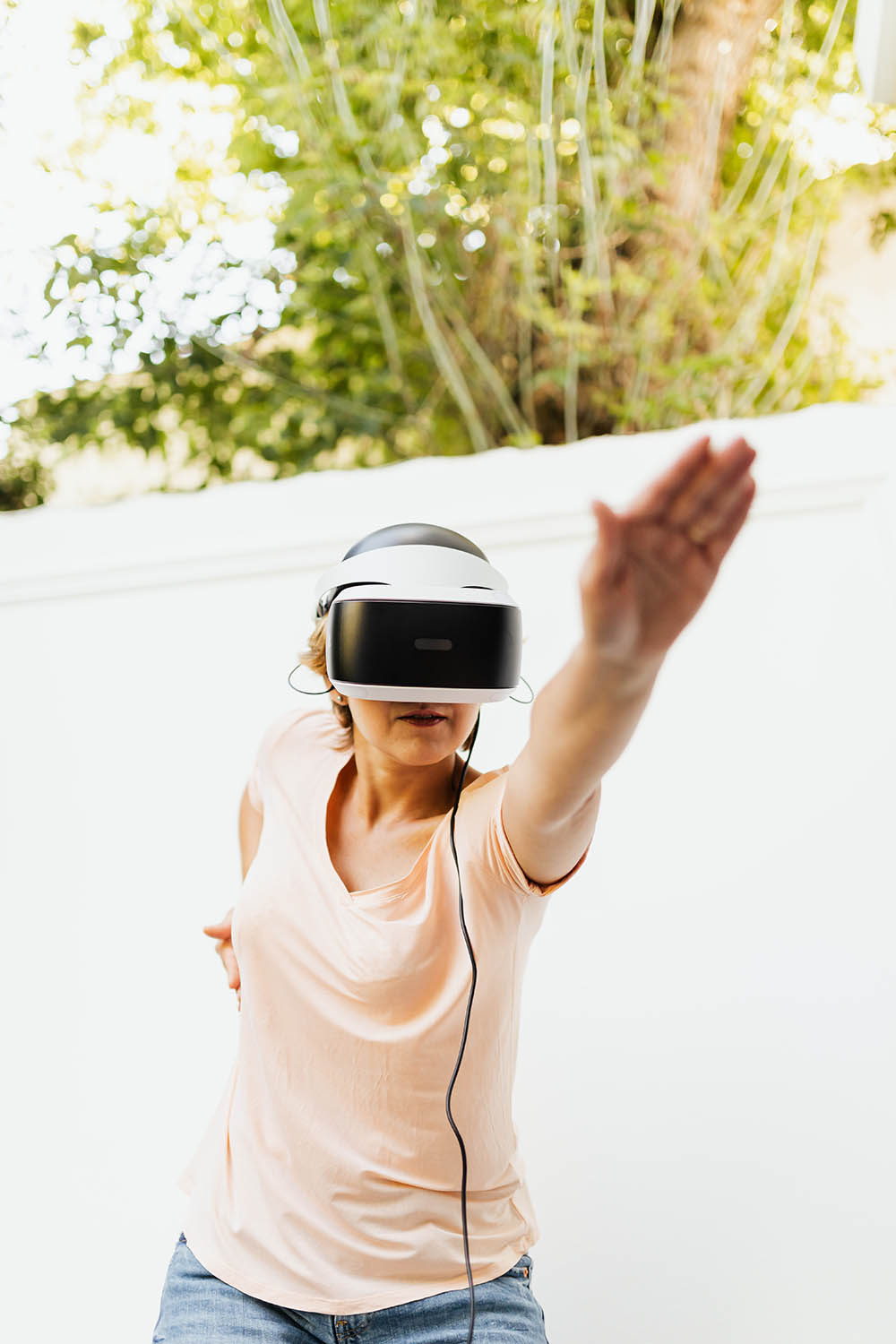 Person doing a yoga pose while wearing a virtual reality headset.