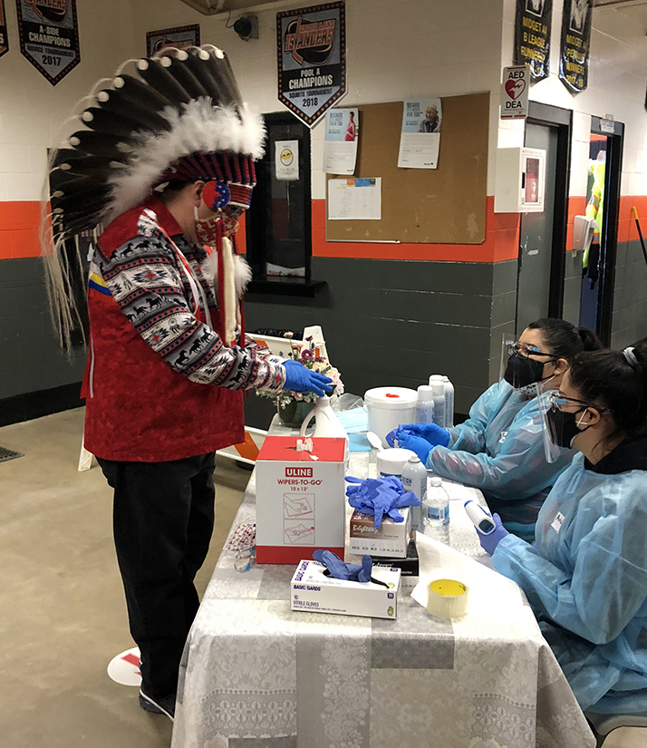 Chief David Monias of Pimicikamak Cree Nation checks in to be vaccinated at Cross Lake Arena, which served as a centre for immunizing the community.