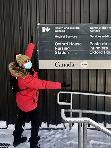 Dental student Rita Pucci poses with Oxford House Nursing Station sign.