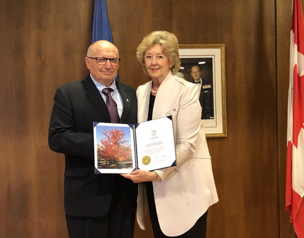 Brian Postl receiving an award from Janice Filmon, Lieutenant Governor of Manitoba.