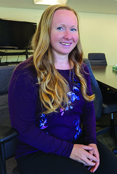 Elizabeth Stoesz sits at her desk.