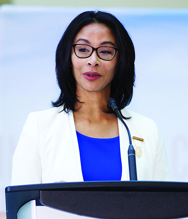 Gigi Osler speaks at a podium.