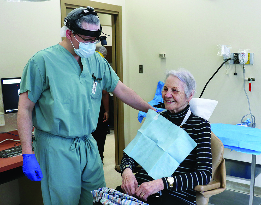 Dr. Ryan McCoy, an oral surgery resident, talks with Catherine Hyska.