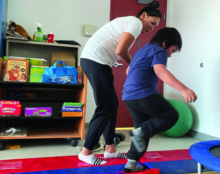 A physiotherapist working with a child.