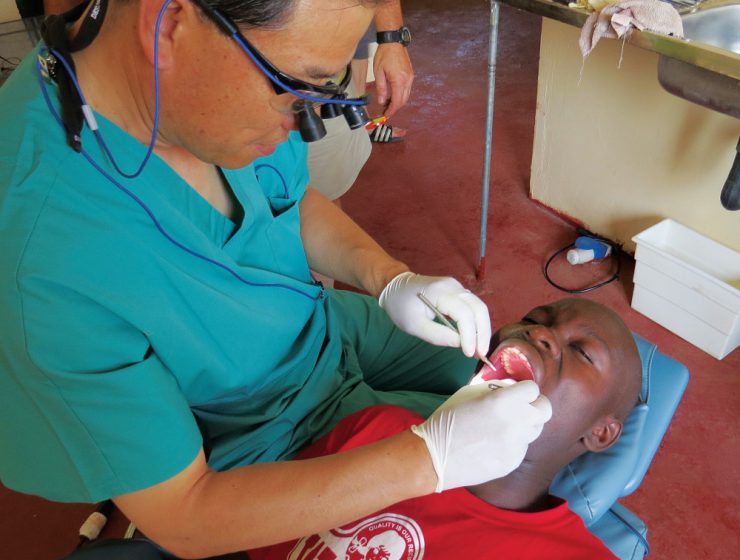 Dr. Aaron Kim performs a dental procedure on a patient.