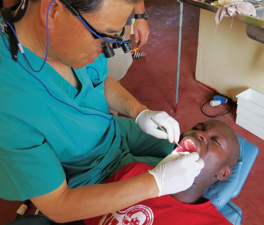 Dr. Aaron Kim performs a dental procedure on a patient.