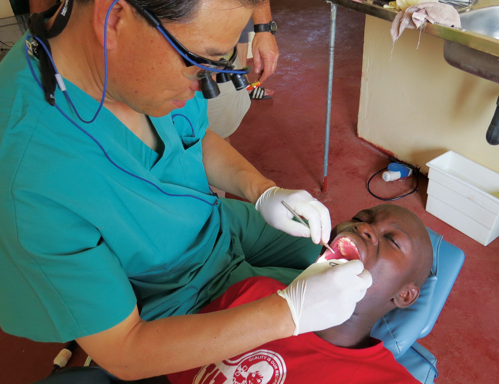 Dr. Aaron Kim performs a dental procedure on a patient.