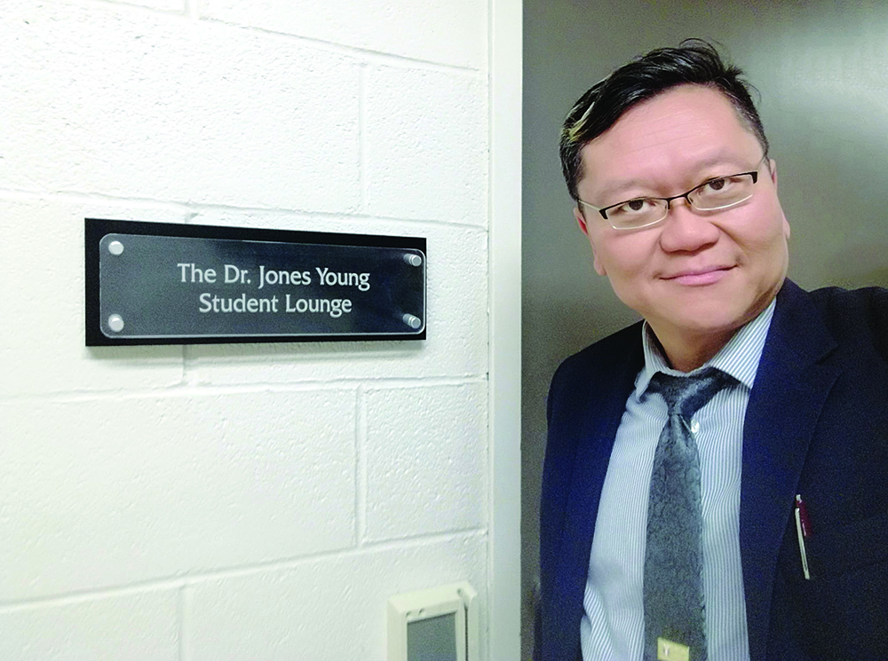 Jones Young stands outside the student lounge named for him.