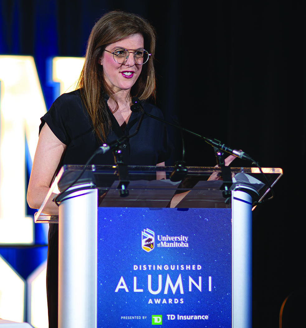 Dr. Tracie Afifi standing at a podium