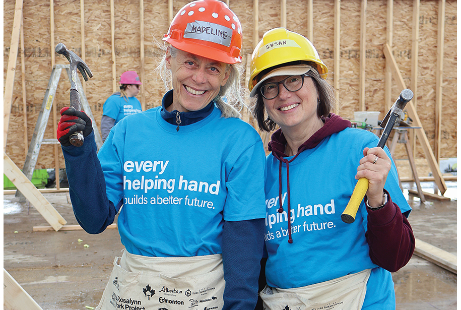 Two women holding hammers