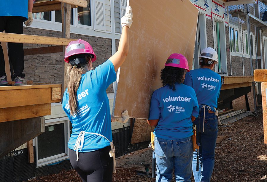 Workers carrying a board.