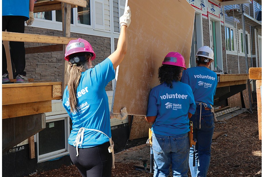 Workers carrying a board.