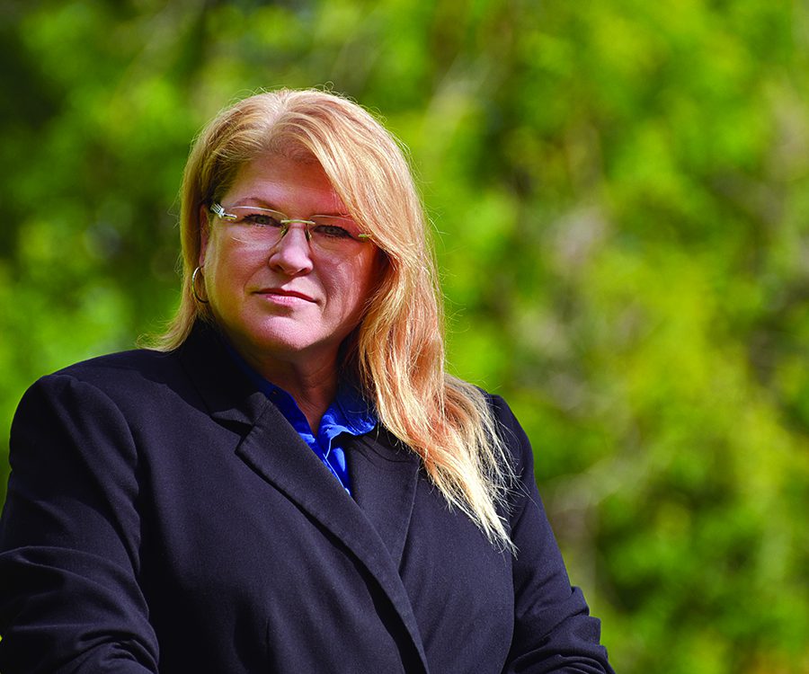 Karen Samson stands outside.