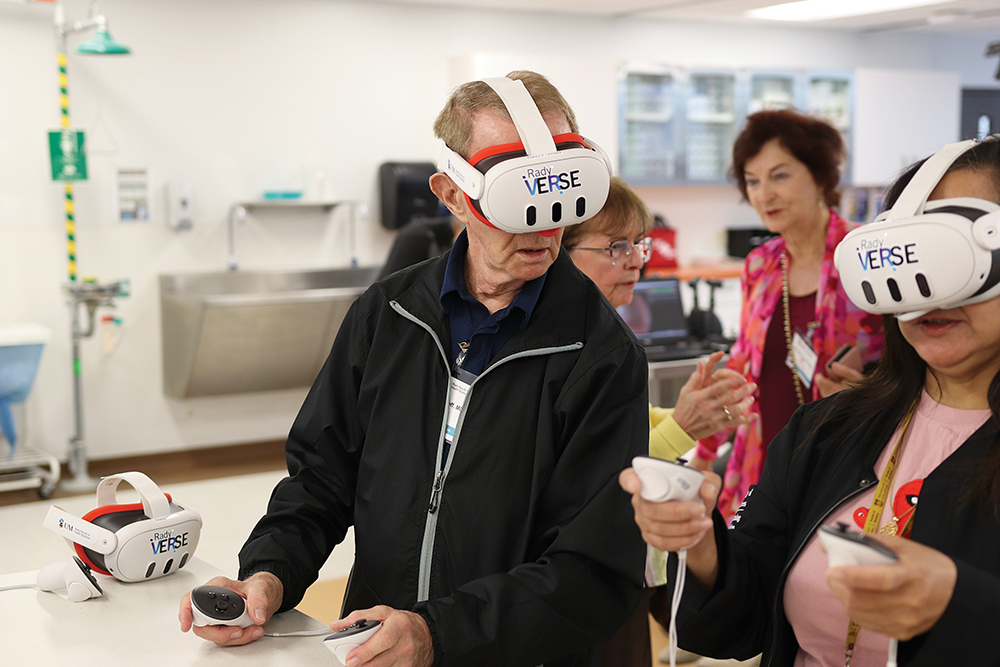 Two people are wearing virtual reality headsets. 