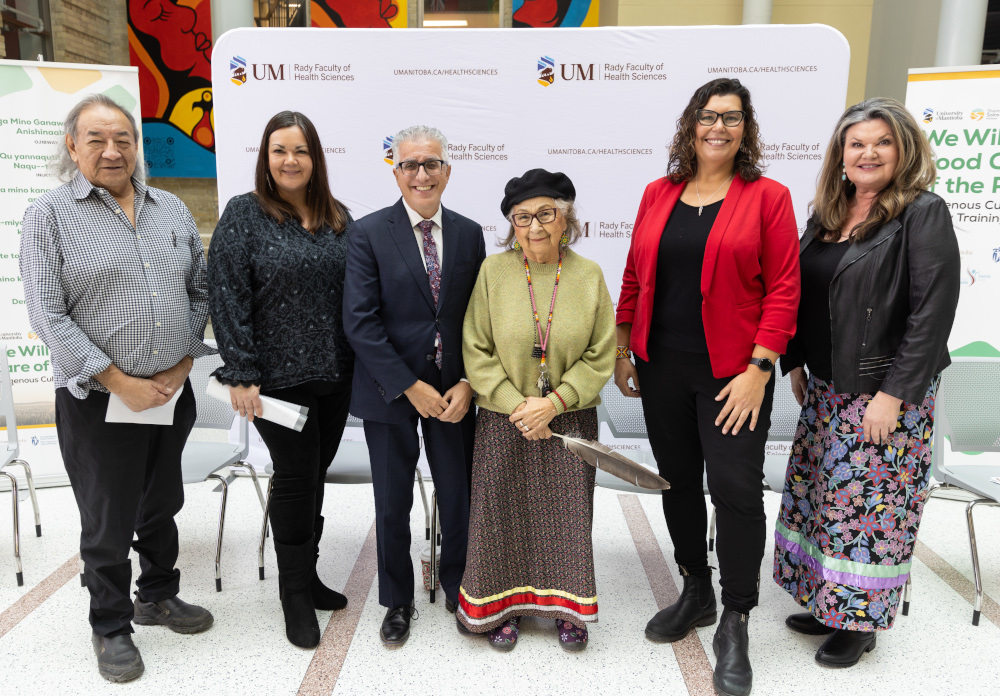 Six people pose for a photo. 