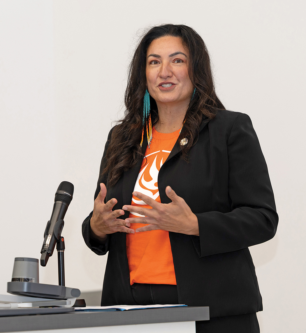 Angie Bruce speaks at a podium.