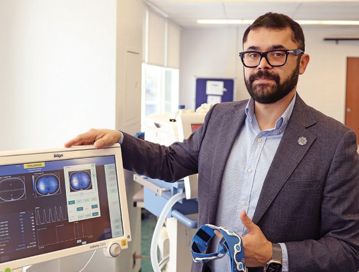 Dr. Mayson Sousa demonstrates an electrical impedance tomography machine.